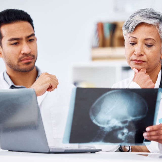 Doctor and patient examining a brain scan